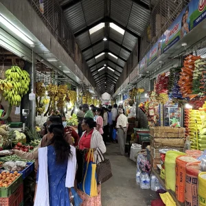 Busy Central Market with hanging bananas and fresh produce in Nuwara Eliya, Sri Lanka