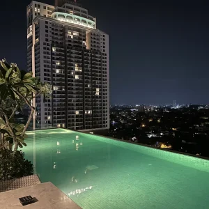 Rooftop infinity pool with green lighting and Colombo city skyline at Jetwing Hotel, Sri Lanka