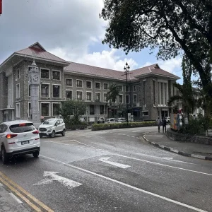 Liberty House government building with Victoria Clock Tower during rain in Victoria, Seychelles
