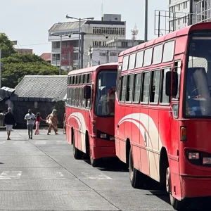 Red public buses parked at transport station in Mauritius showing local transportation