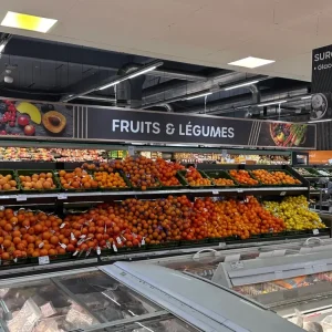 Fresh fruits and vegetables section in Mauritius supermarket with French signage