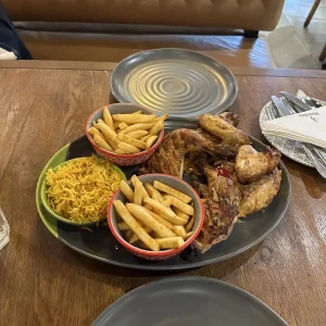 Nando's PERi-PERi grilled chicken platter with fries and rice in Bengaluru, India