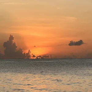 Tropical sunset over ocean with golden clouds and calm waters in Seychelles