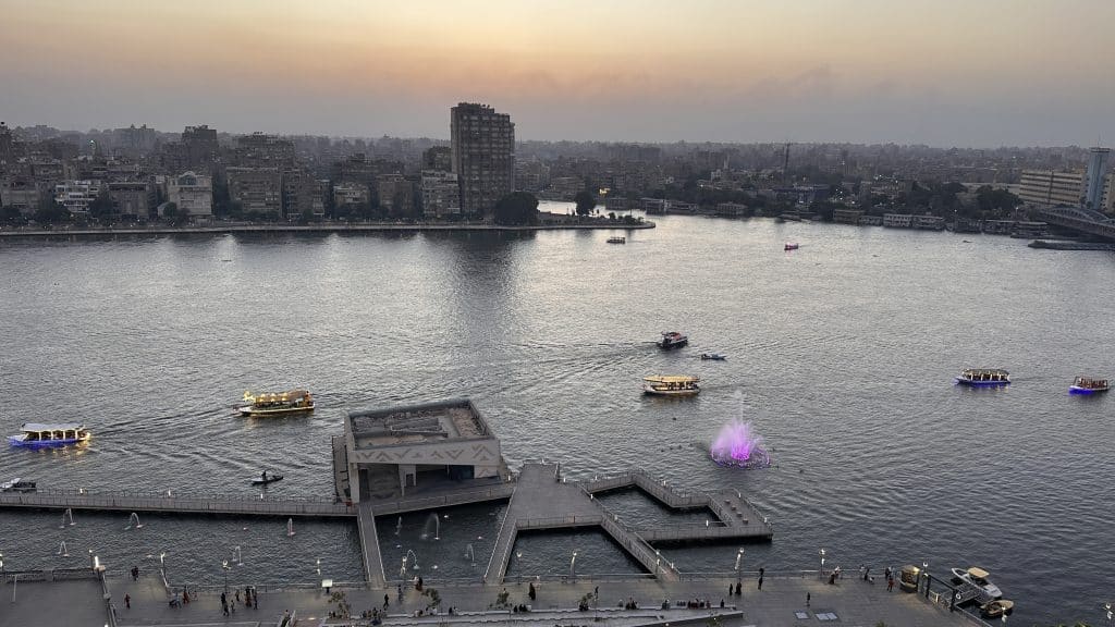 Sunset view over the Nile Corniche and the Nile River in Cairo featuring illuminated boats, a relaxing start to this 10-Day Egypt Itinerary.