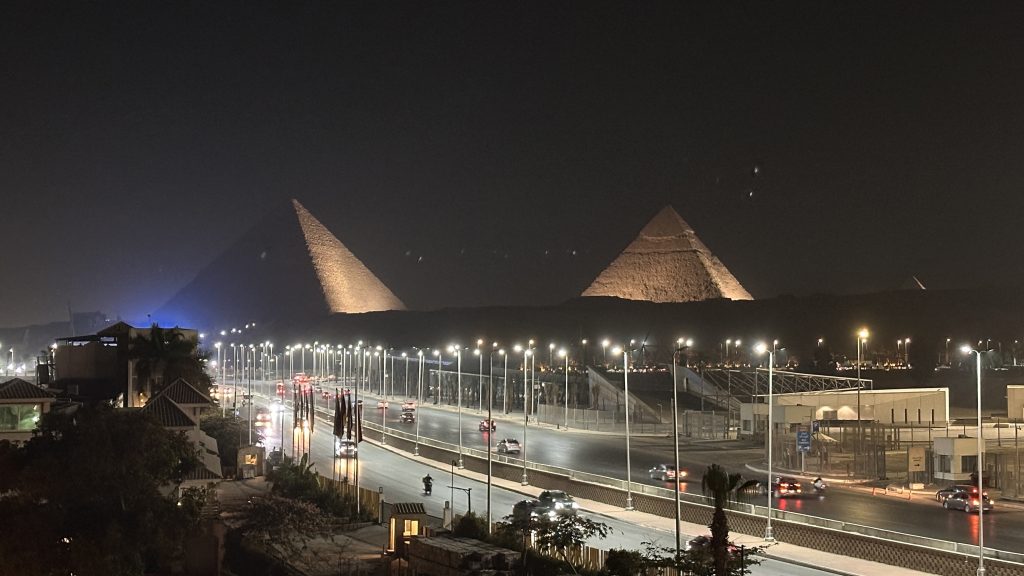 Night view of the Pyramids of Giza lit up above the main road in Giza, Egypt, on Day 2 of a 10-day Egypt itinerary.