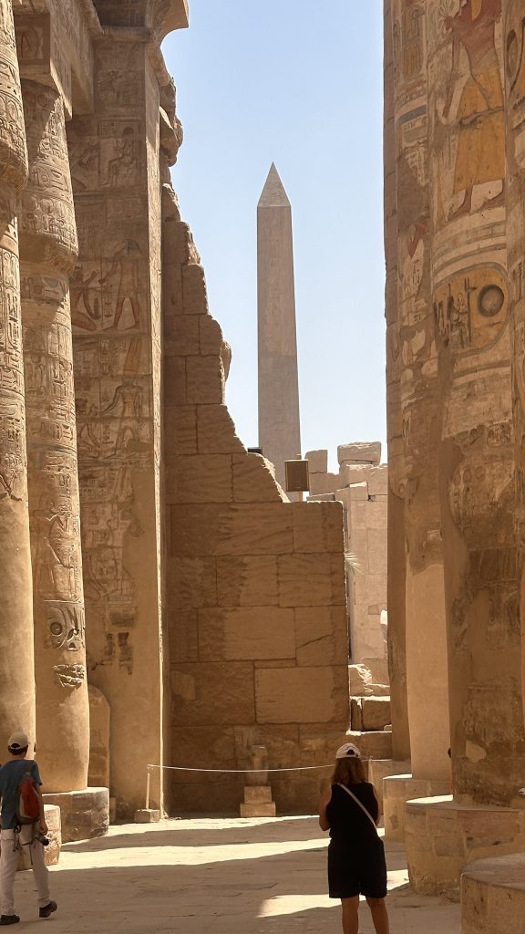 Obelisk framed by carved sandstone columns inside Karnak Temple in Luxor on Day 8 of a 10-Day Egypt Itinerary.