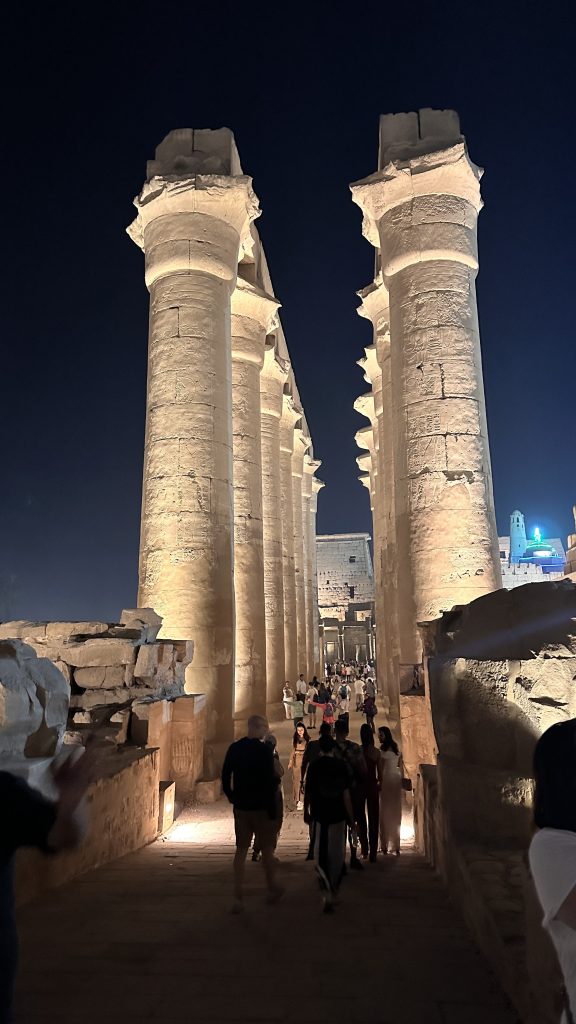 Visitors walking through the illuminated columned court of Luxor Temple at night on a 10-day Egypt itinerary.