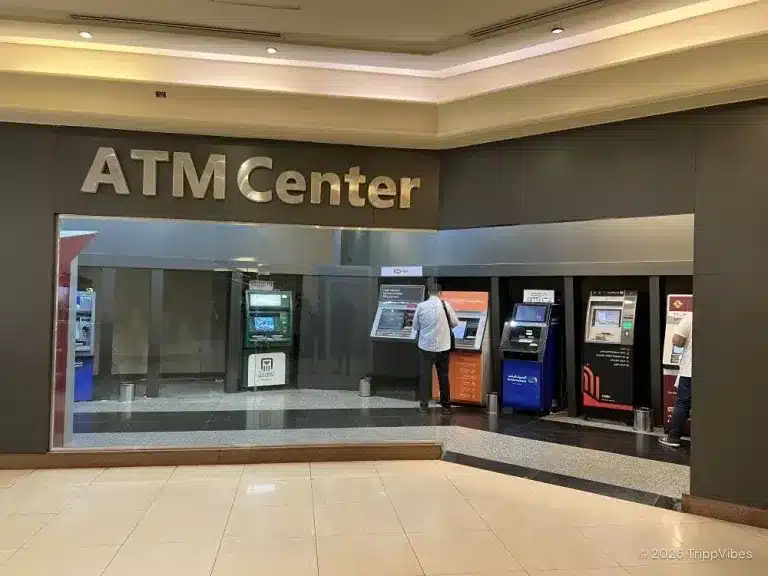 Dedicated shopping centre bay with a row of bank cash machines beneath an atm centre sign from our travel money guide